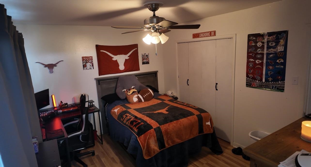 2709 Rice Avenue San Angelo, TX 76904 - Photo 15 of 28 a bedroom with a bed and a bookshelf