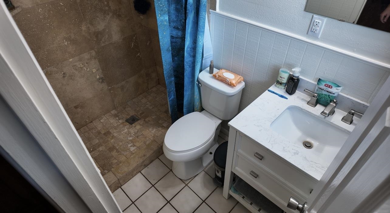 2709 Rice Avenue San Angelo, TX 76904 - Photo 17 of 28 a bathroom with a sink a toilet and a shower