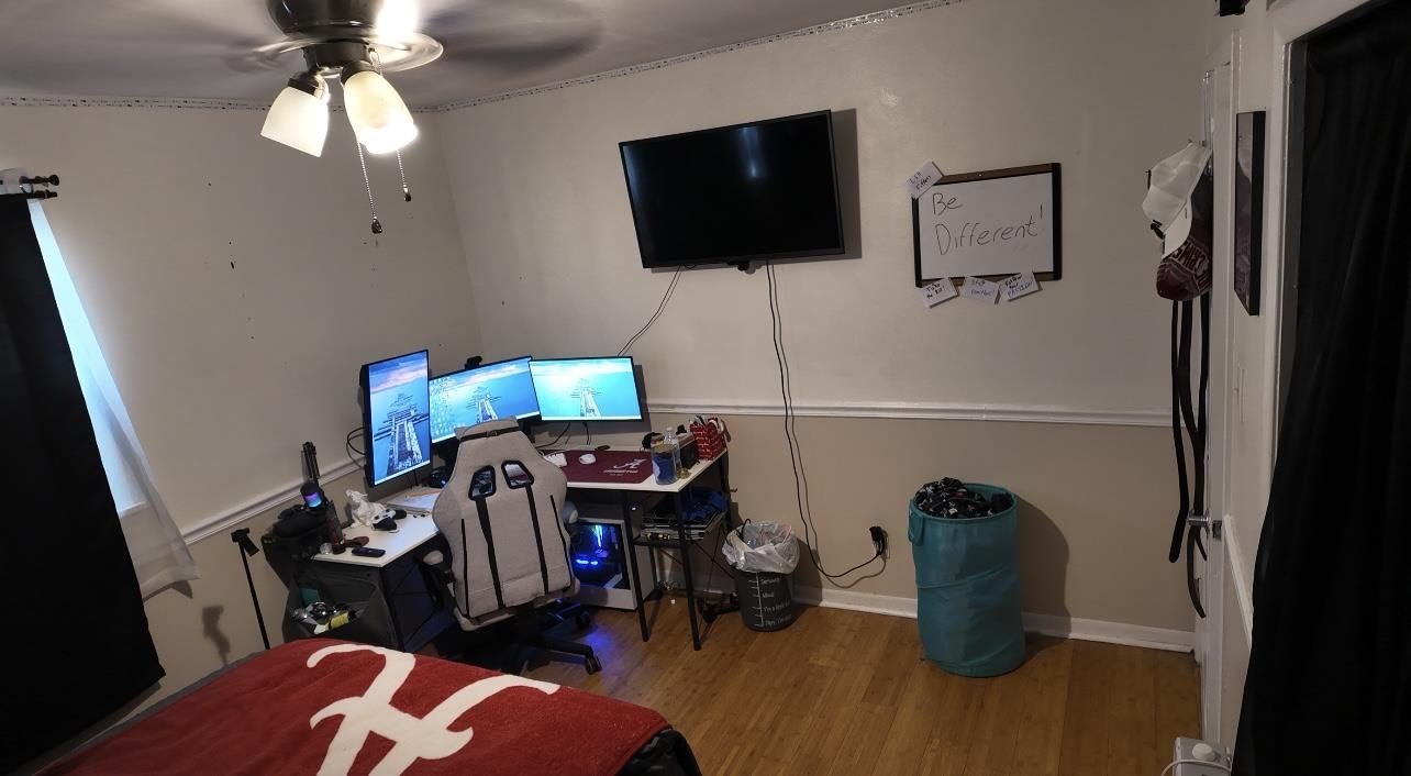 2709 Rice Avenue San Angelo, TX 76904 - Photo 19 of 28 a living room with furniture a flat screen tv and a fireplace