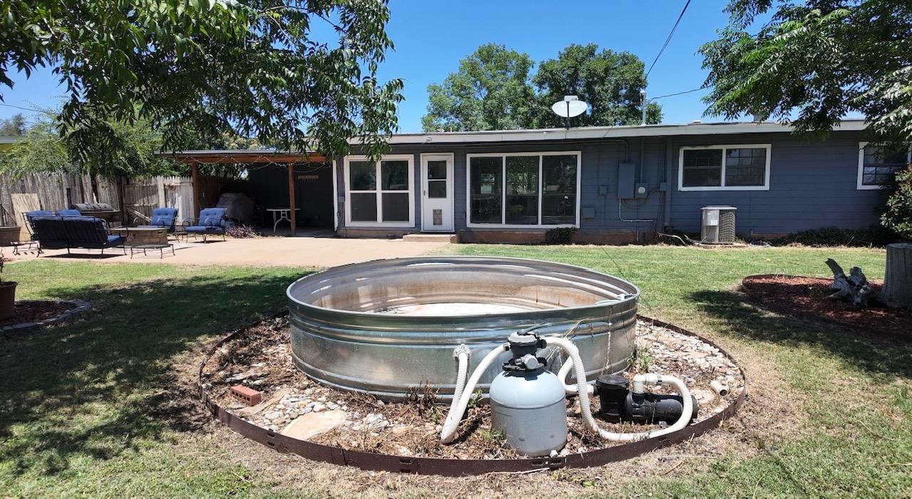 2709 Rice Avenue San Angelo, TX 76904 - Photo 22 of 28 a view of a house with backyard sitting area and fire pit