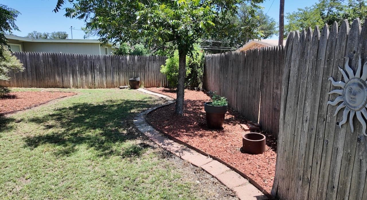 2709 Rice Avenue San Angelo, TX 76904 - Photo 23 of 28 a view of a backyard with chairs and a stove
