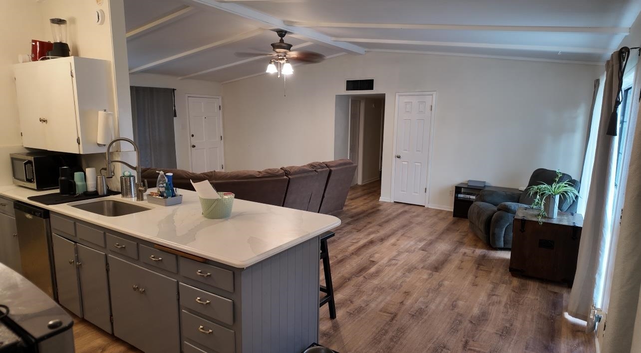 2709 Rice Avenue San Angelo, TX 76904 - Photo 7 of 28 a kitchen with a sink cabinets and wooden floor