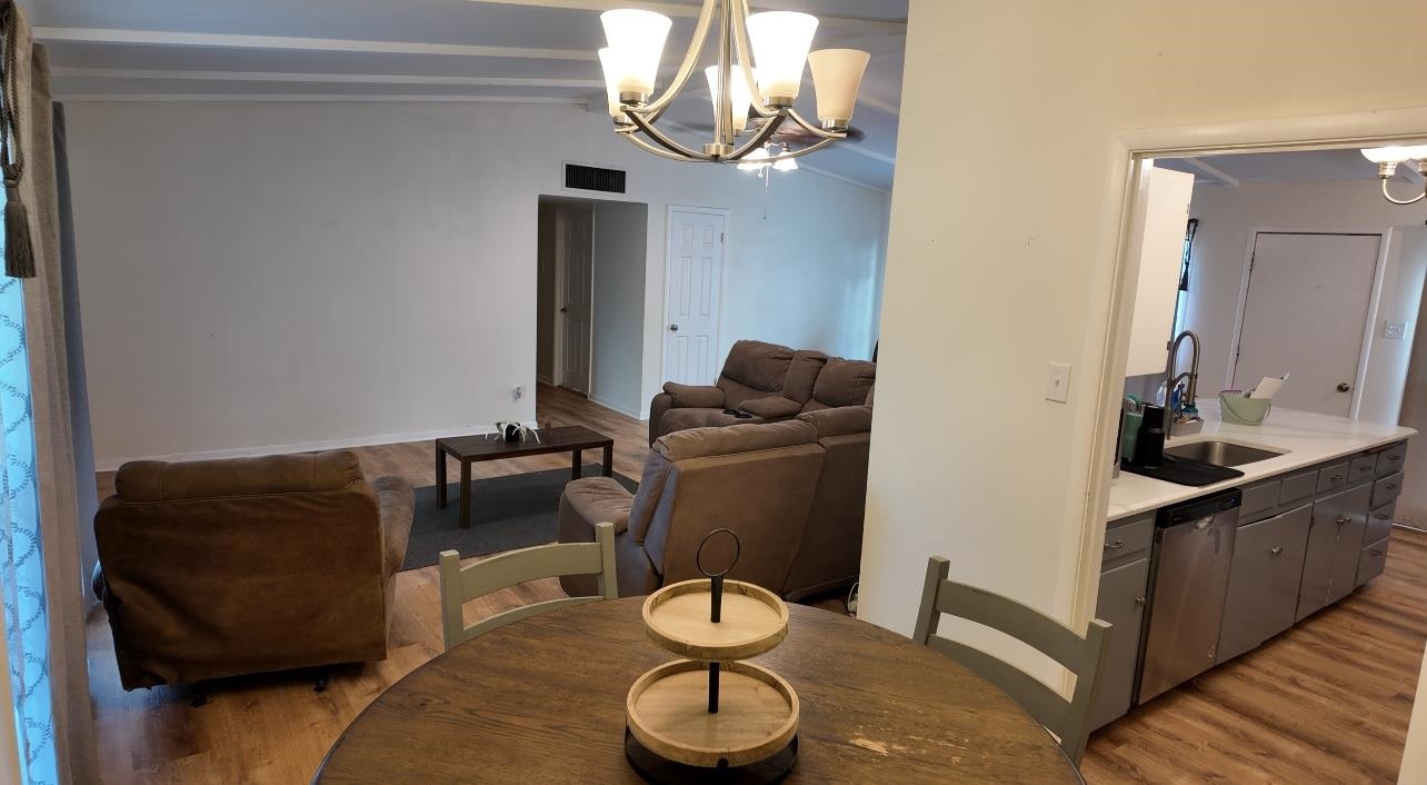 2709 Rice Avenue San Angelo, TX 76904 - Photo 9 of 28 a living room with furniture flowerpot and a chandelier