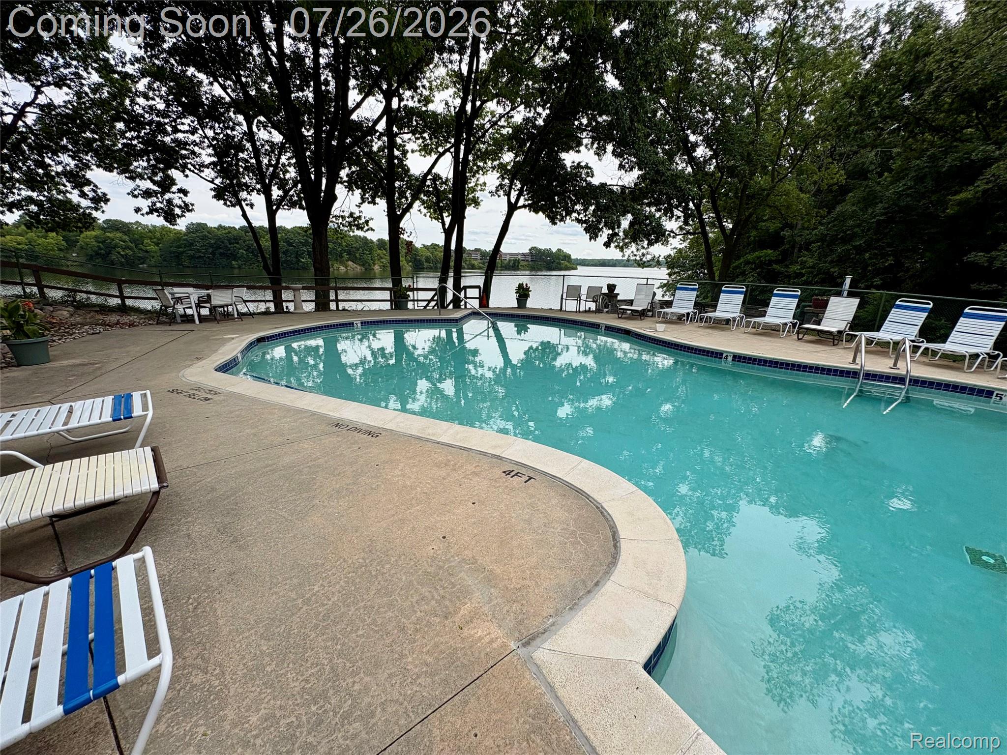 1736 Grove Road, Unit 102 Ypsilanti, MI 48198 - Photo 16 of 36 Swimming pool with a concrete surround and a natural water backdrop