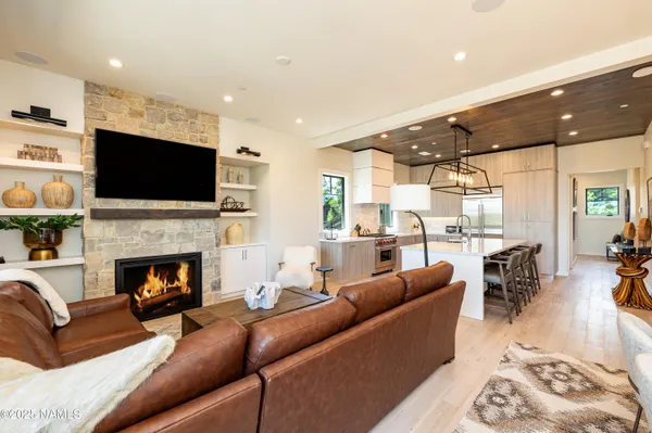 a living room with furniture fireplace and flat screen tv