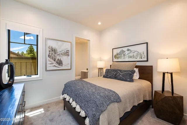 a bedroom with a bed and a lamp on table