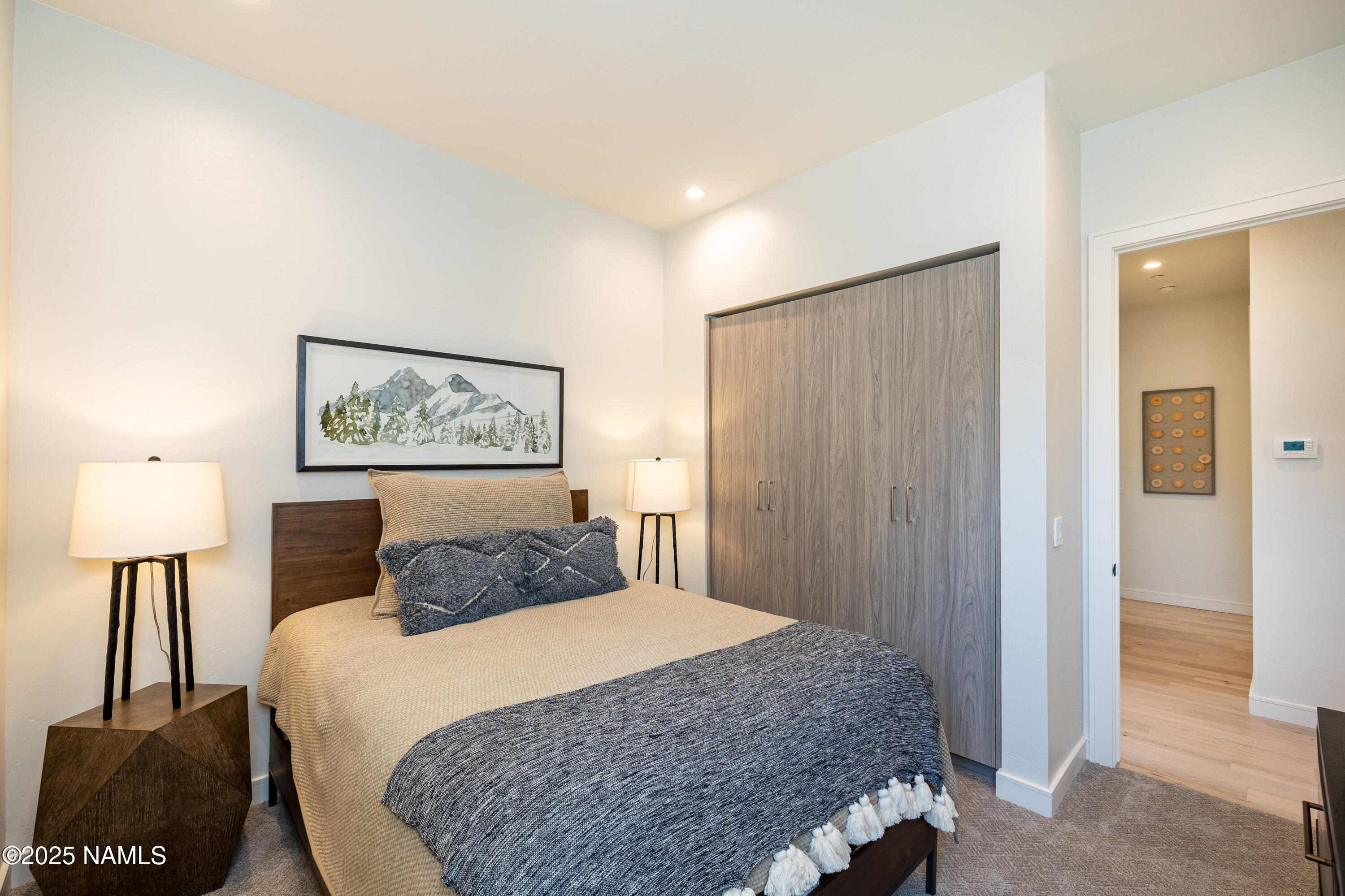 3001 South Tourmaline Drive, Unit 28 Flagstaff, AZ 86005 - Photo 18 of 41 a bedroom with a bed and a lamp on table