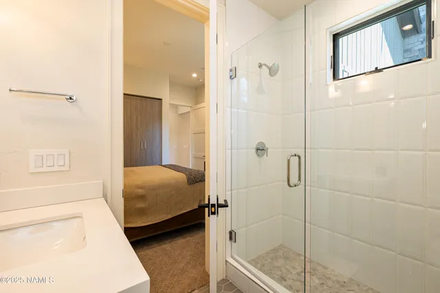 a bedroom with a large bed and a large window