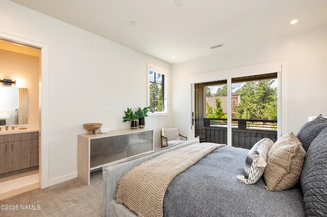 a spacious bedroom with a bed and a couch