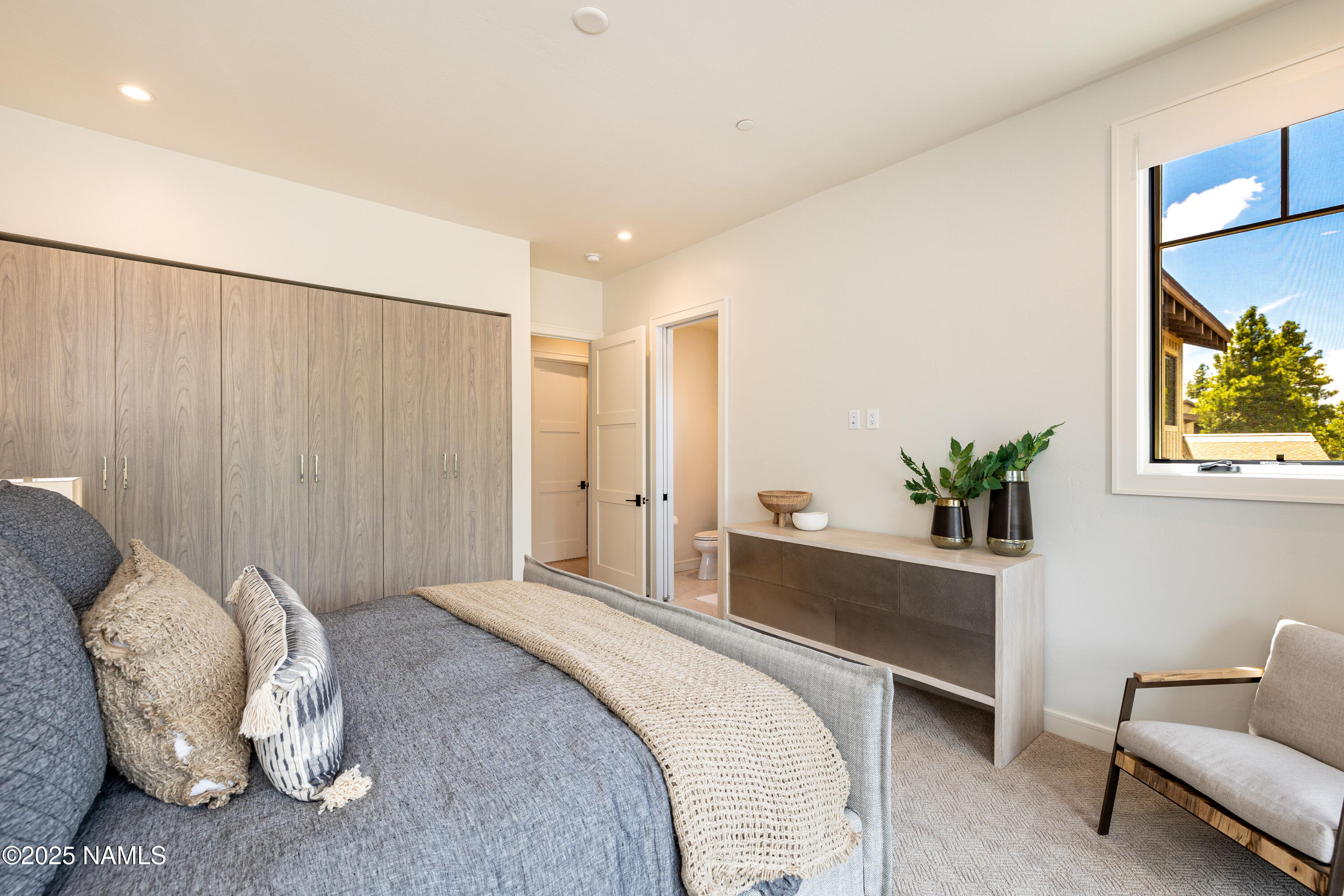 3001 South Tourmaline Drive, Unit 28 Flagstaff, AZ 86005 - Photo 23 of 41 a spacious bedroom with a bed and a couch