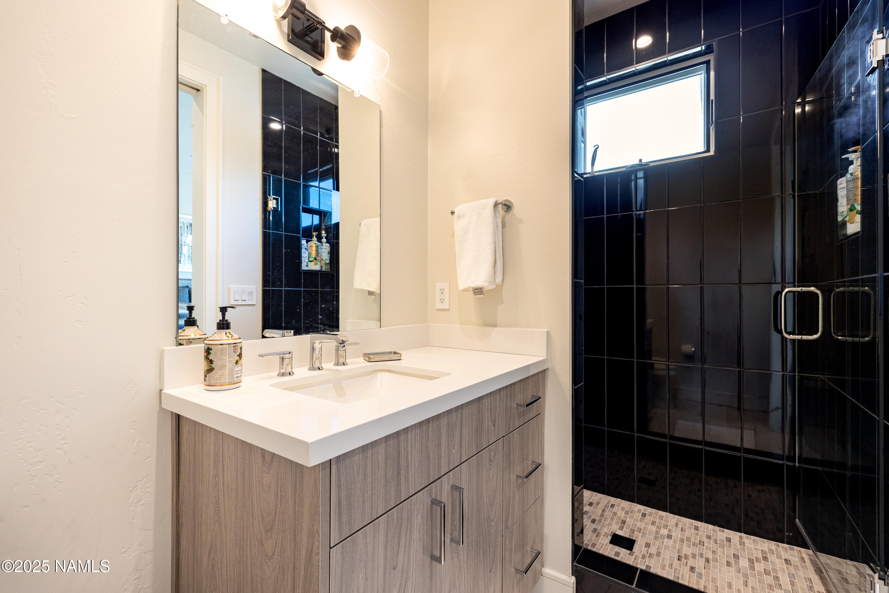 3001 South Tourmaline Drive, Unit 28 Flagstaff, AZ 86005 - Photo 26 of 41 a bathroom with a sink and a mirror