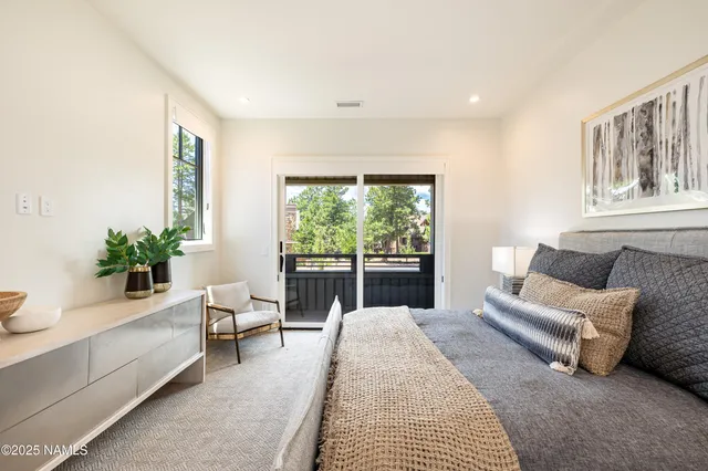 a bedroom with a large bed and a large window