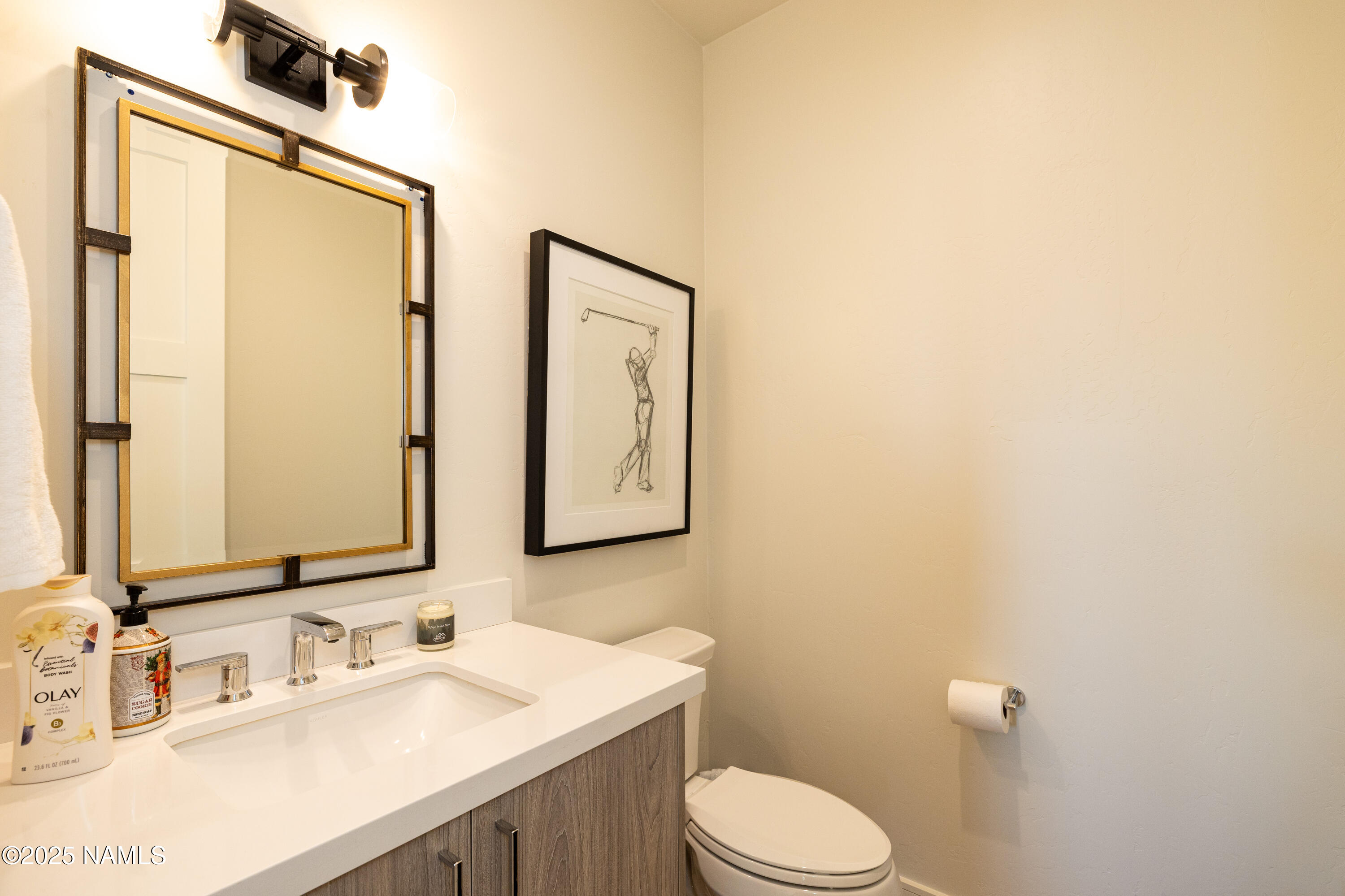 3001 South Tourmaline Drive, Unit 28 Flagstaff, AZ 86005 - Photo 28 of 41 a bathroom with a sink vanity mirror and toilet