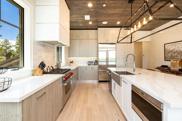 a large kitchen with a stove and a sink