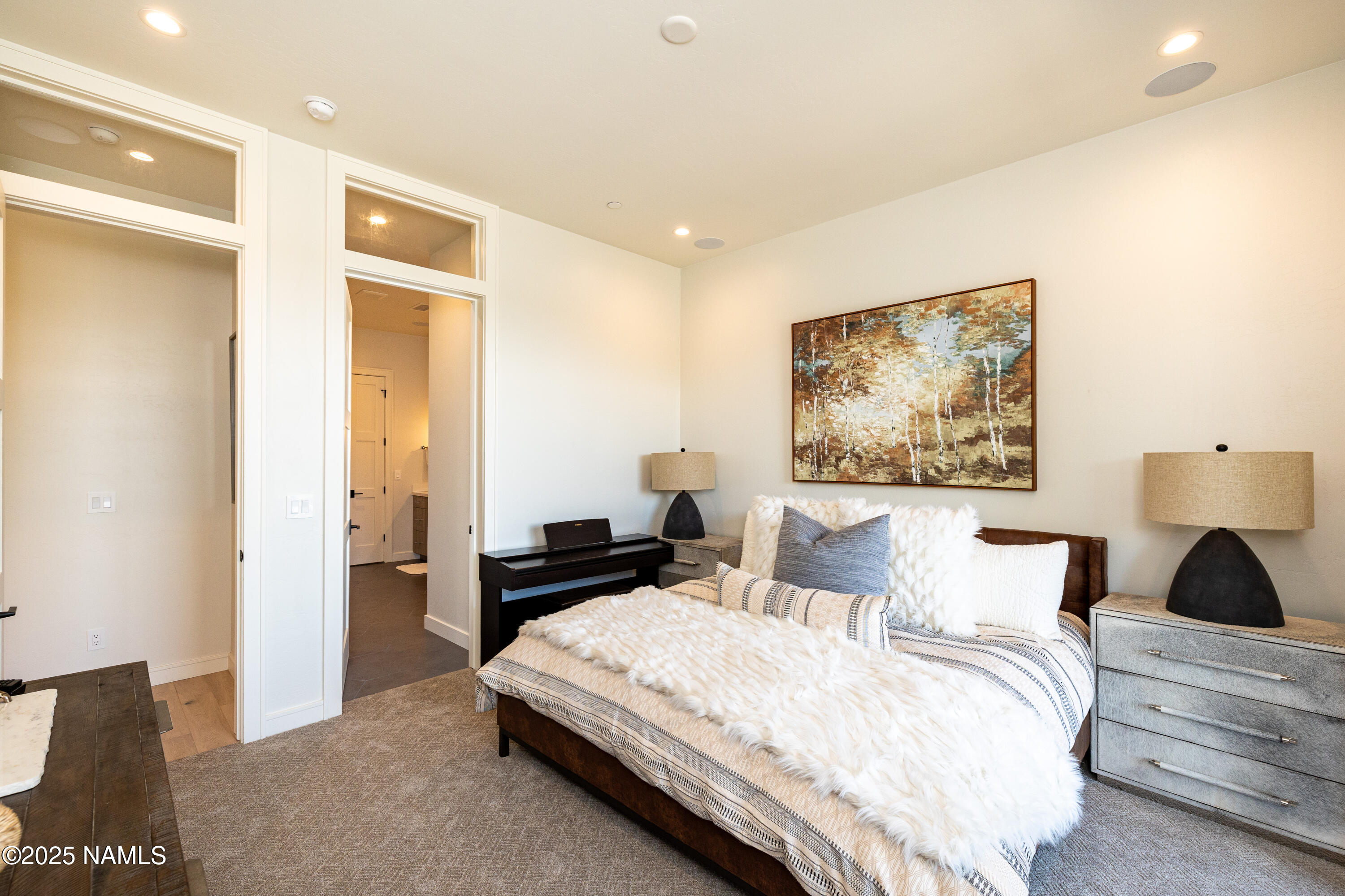 3001 South Tourmaline Drive, Unit 28 Flagstaff, AZ 86005 - Photo 32 of 41 a bedroom with a bed and a painting on the wall