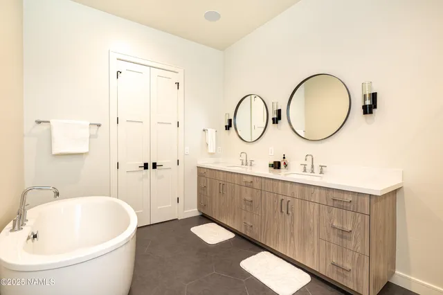 a white bath tub sitting next to a white sink