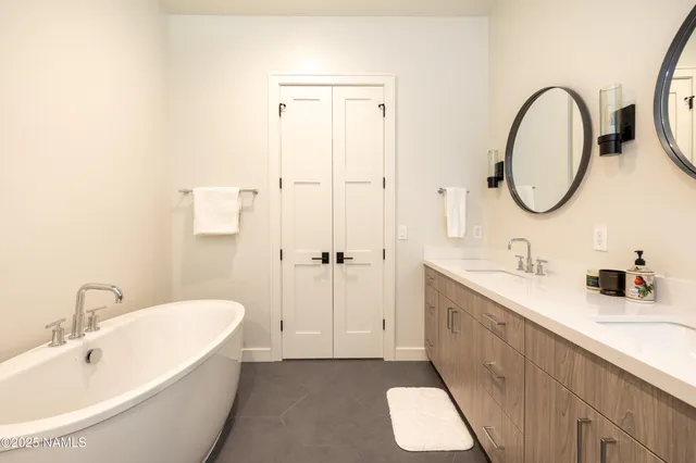 a bathroom with a double vanity sink toilet and shower