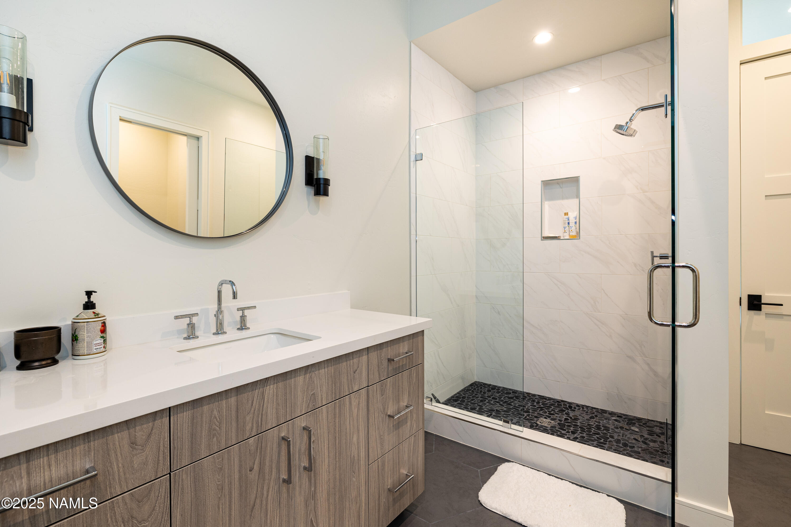 3001 South Tourmaline Drive, Unit 28 Flagstaff, AZ 86005 - Photo 37 of 41 a bathroom with a sink a toilet and a mirror