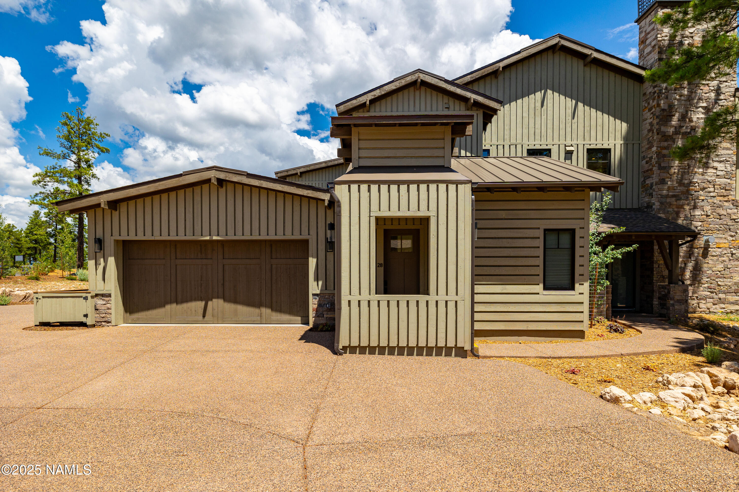3001 South Tourmaline Drive, Unit 28 Flagstaff, AZ 86005 - Photo 41 of 41 a front view of a house with a yard and garage