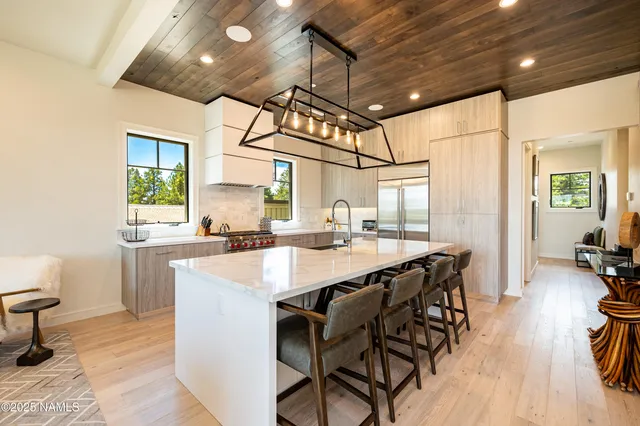 a large kitchen with a table and chairs in it