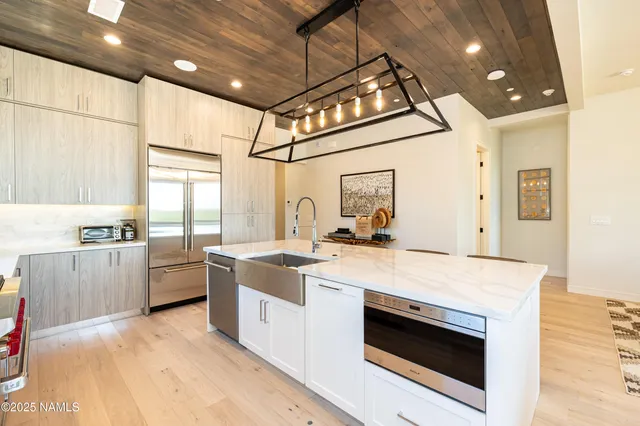 a kitchen with counter top space a stove and wooden floor