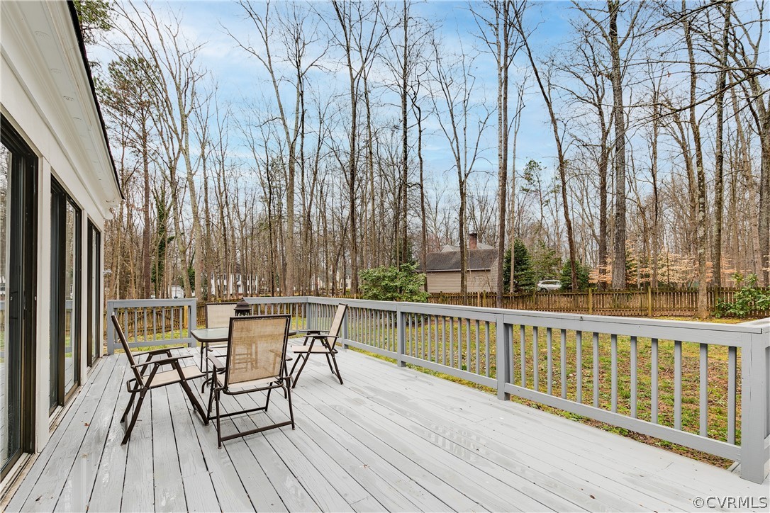 3180 East Brigstock Road Midlothian, VA 23113 - Photo 46 of 50 a view of a chairs and table on the wooden deck