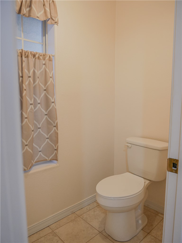 2575 Triangle S Street Kingman, AZ 86401 - Photo 26 of 45 a white toilet sitting next to a shower curtain
