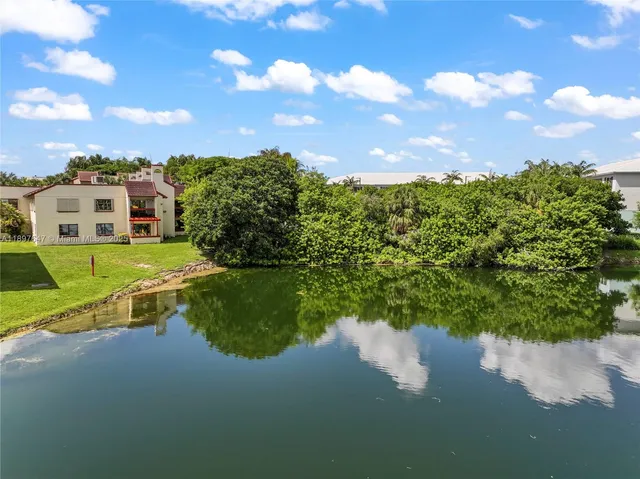 a view of a lake with a house in the background