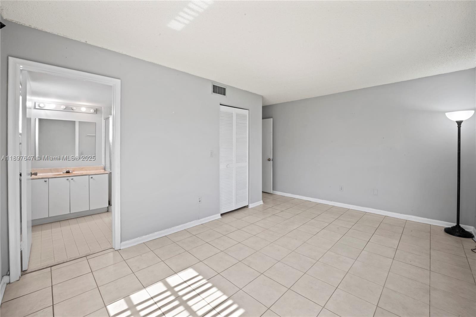 8530 Southwest 149th Avenue, Unit 906 Miami, FL 33193 - Photo 12 of 20 a view of an empty room and window