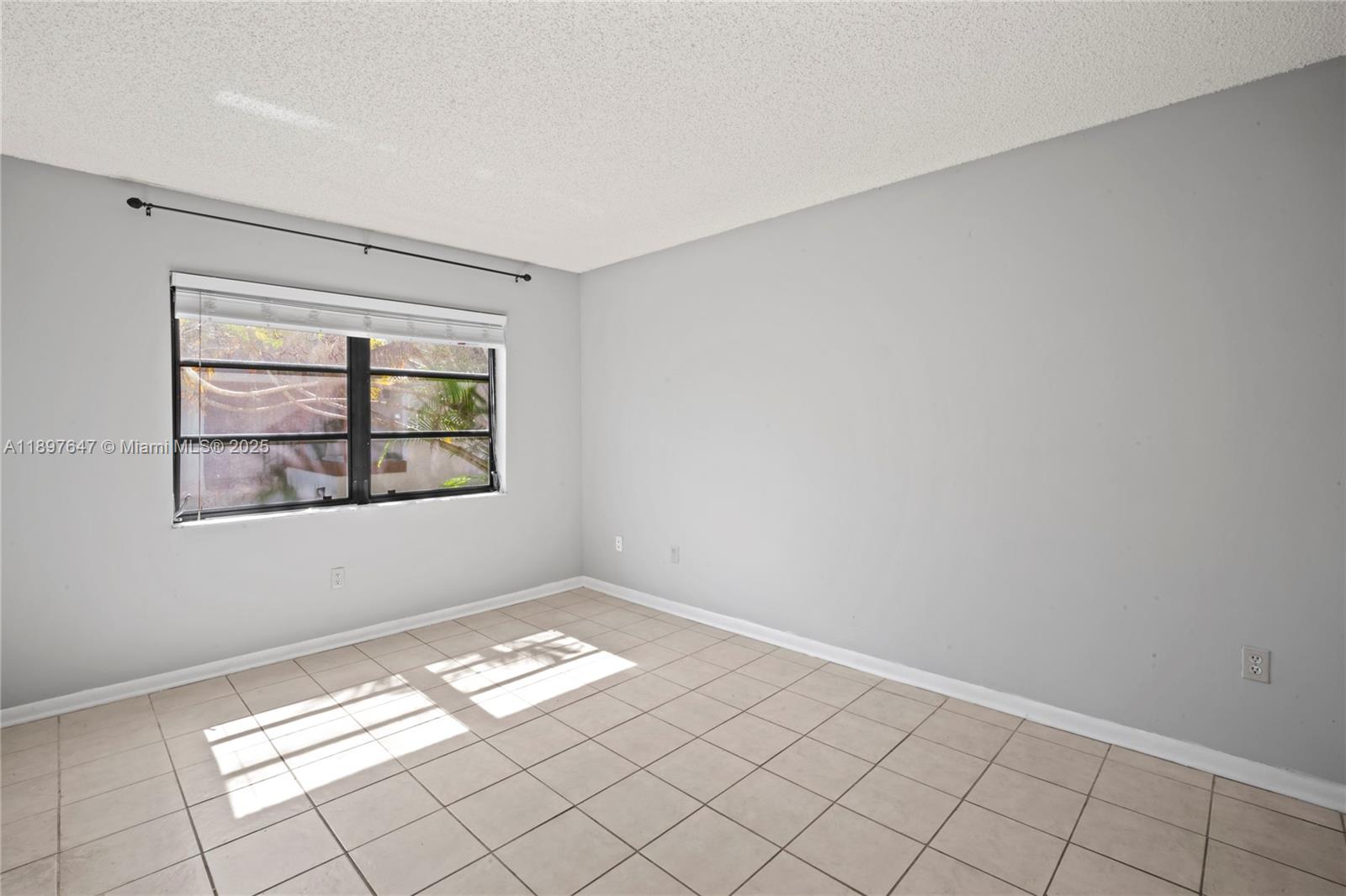 8530 Southwest 149th Avenue, Unit 906 Miami, FL 33193 - Photo 13 of 20 a view of empty room with window