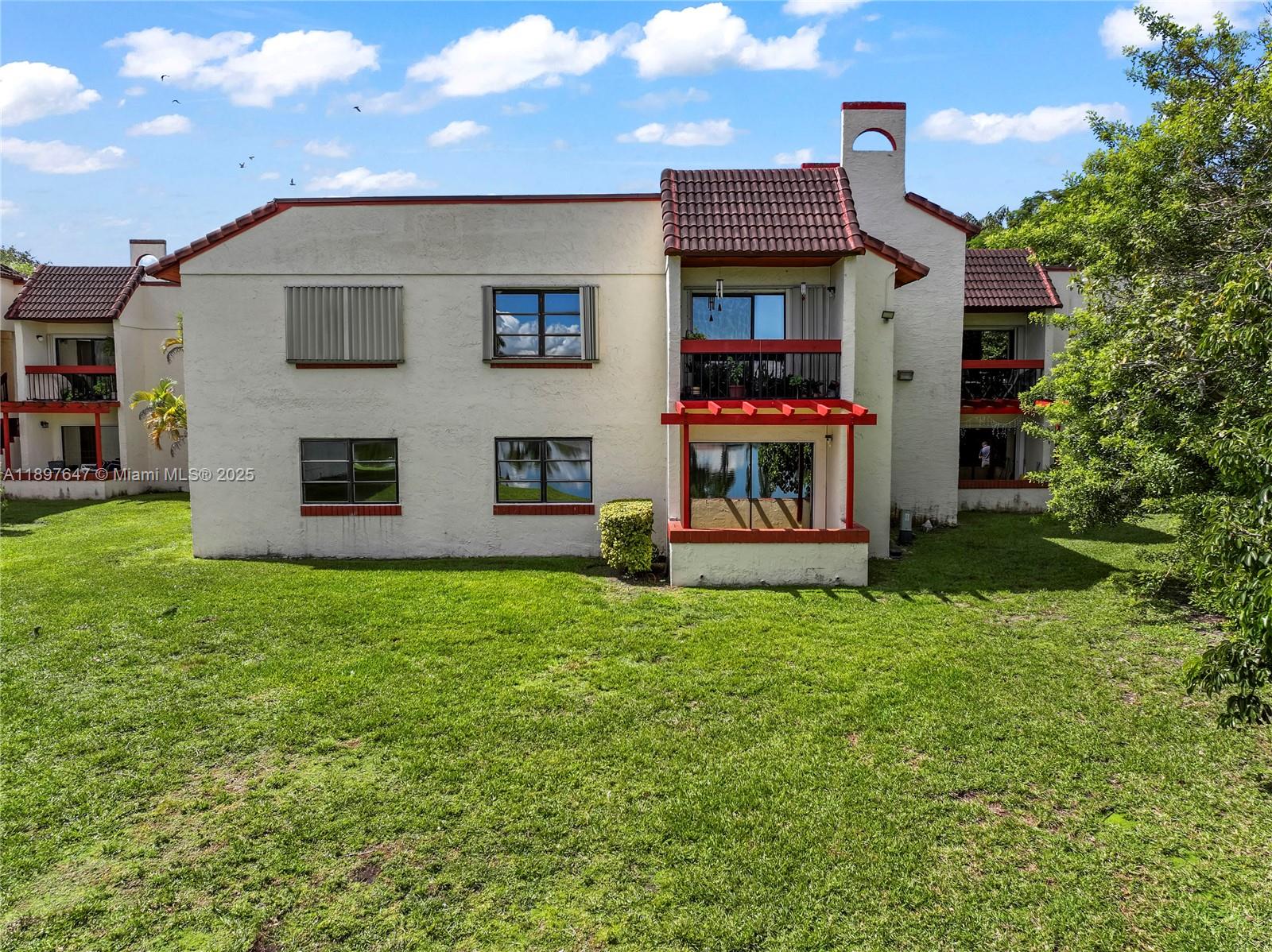 8530 Southwest 149th Avenue, Unit 906 Miami, FL 33193 - Photo 17 of 20 a view of a house with a yard