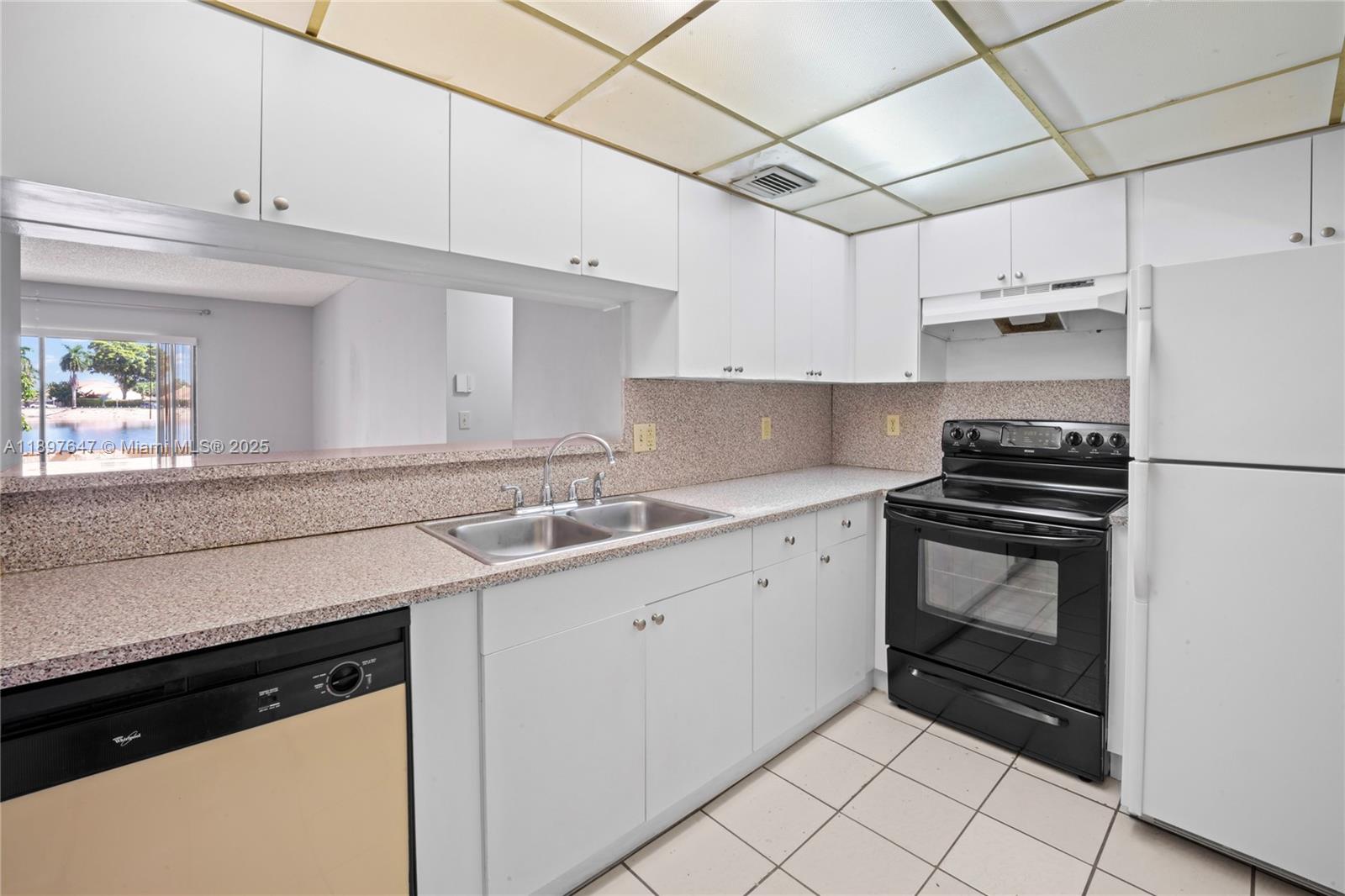 8530 Southwest 149th Avenue, Unit 906 Miami, FL 33193 - Photo 8 of 20 a kitchen with a sink appliances and cabinets
