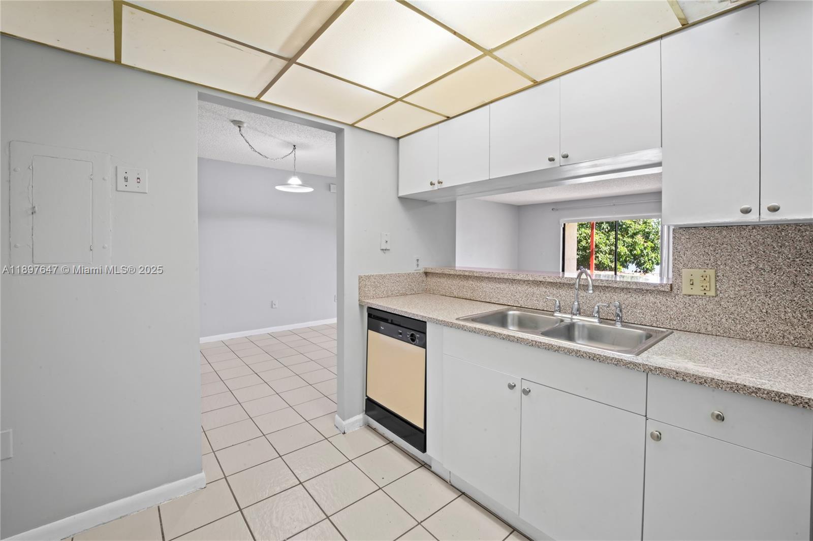 8530 Southwest 149th Avenue, Unit 906 Miami, FL 33193 - Photo 9 of 20 a kitchen with a sink cabinets and window
