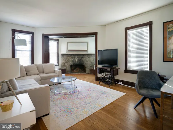 a living room with furniture flat screen tv and a fireplace