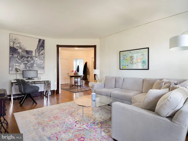 a living room with furniture wooden floor and a table