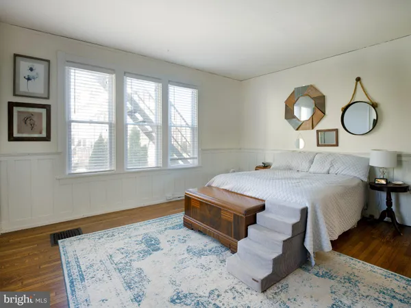 a bedroom with a bed and a large window