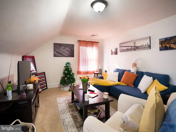 a view of a dining room with furniture and a potted plant