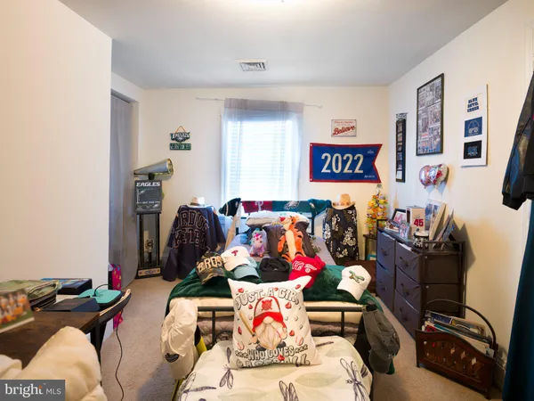 a bedroom with a bed and a couch