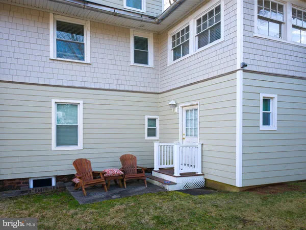 a backyard of a house with table and chairs