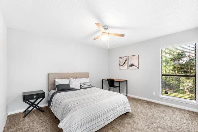 a bedroom with a bed and a table