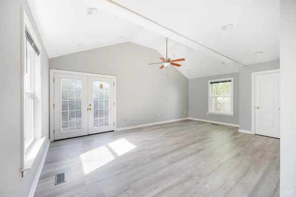a view of empty room with wooden floor