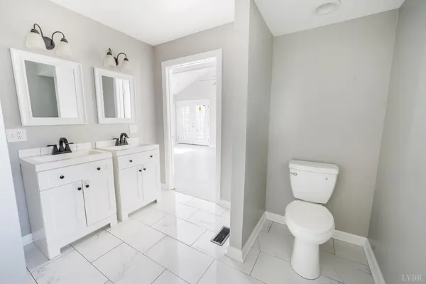 a bathroom with a shower a toilet and a shower