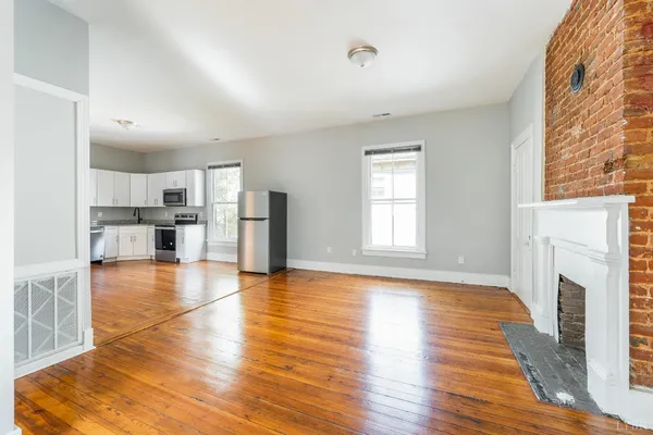 a view of a room with wooden floor and a window