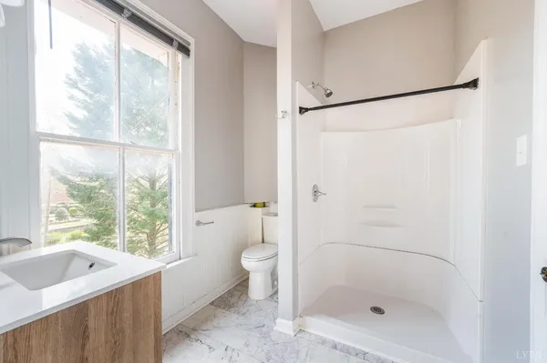 a white toilet sitting next to a window