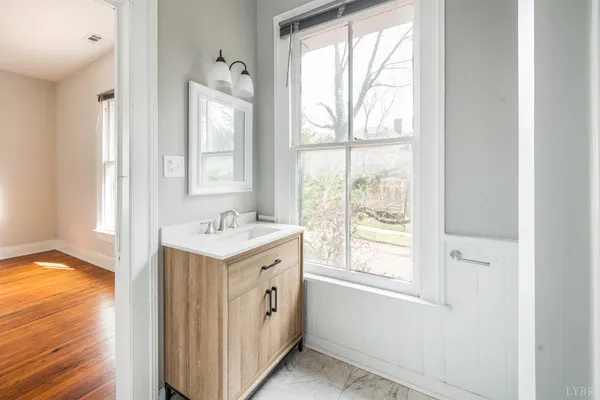 a view of a house with a yard and wooden fence