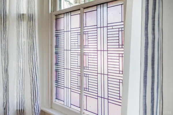a view of empty room with wooden floor and fireplace