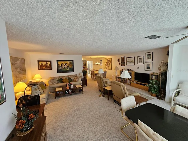 a living room with fireplace furniture and a flat screen tv