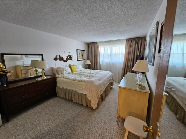 a room with a bed and a lamp on table