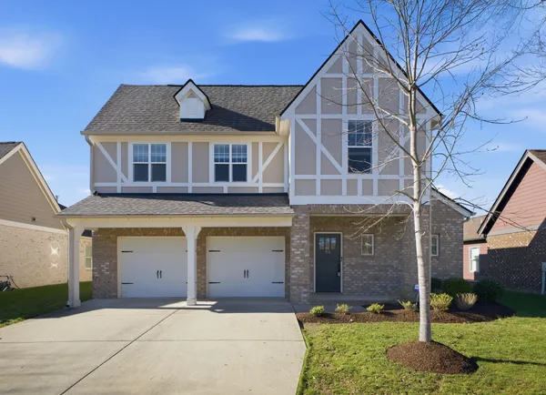 a front view of a house with a yard and garage