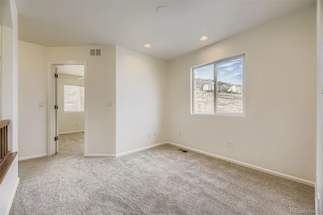 an empty room with windows and closet